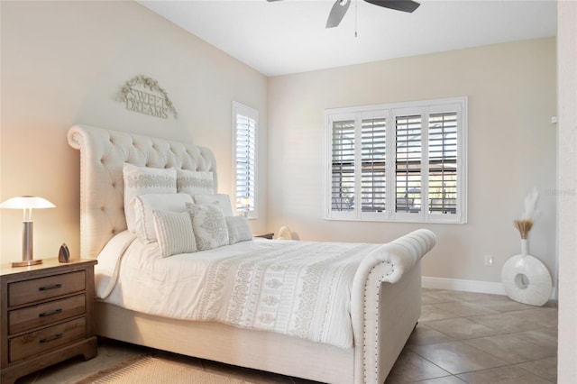 bedroom with tile patterned floors, ceiling fan, baseboards, and multiple windows