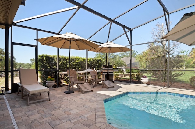 outdoor pool featuring a patio and glass enclosure