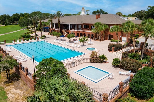 pool featuring fence and a patio