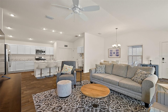 6248 Siverson Ter, The Villages, FL 32163 - living room featuring visible vents, ceiling fan with notable chandelier, dark wood-style flooring, and lofted ceiling