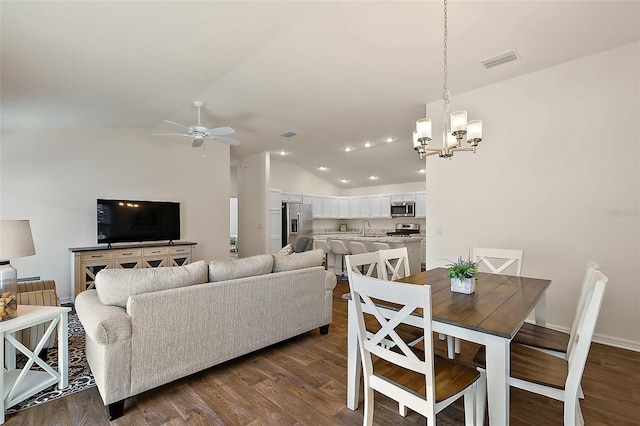 6248 Siverson Ter, The Villages, FL 32163 - dining space with dark wood finished floors, ceiling fan with notable chandelier, recessed lighting, vaulted ceiling, and visible vents