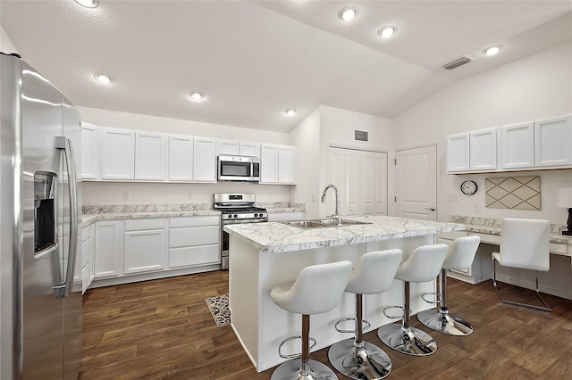 6248 Siverson Ter, The Villages, FL 32163 - kitchen with dark wood-style flooring, appliances with stainless steel finishes, a sink, lofted ceiling, and visible vents