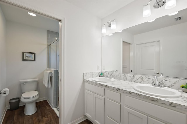 6248 Siverson Ter, The Villages, FL 32163 - bathroom with toilet, visible vents, a shower stall, and a sink