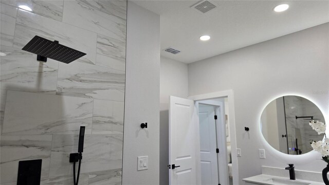 13524 SW 89th St, Dunnellon, FL 34432 - bathroom with a sink, a marble finish shower, recessed lighting, and visible vents
