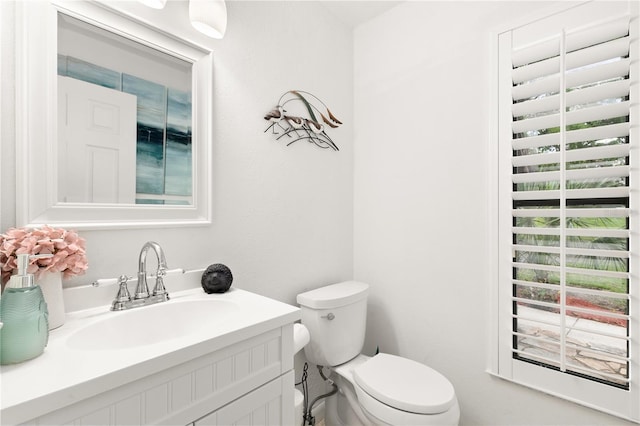 half bath with vanity and toilet