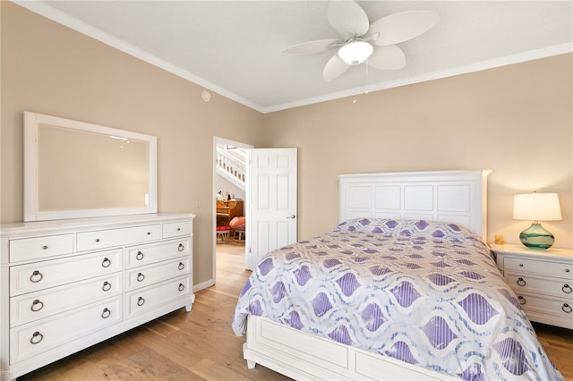 bedroom featuring ornamental molding, a ceiling fan, and light wood-type flooring