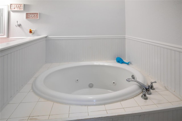 full bath with a tub with jets and wainscoting