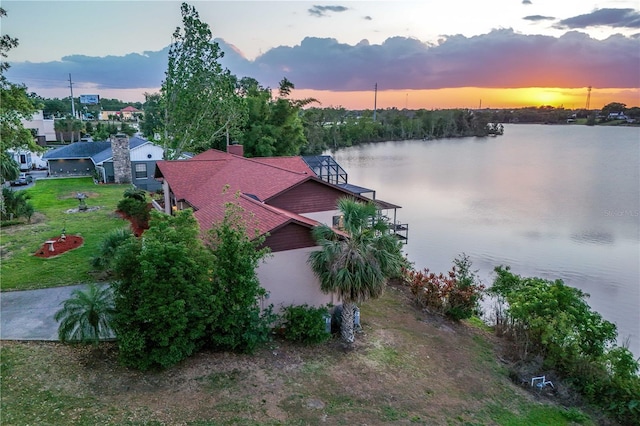 aerial view at dusk with a water view