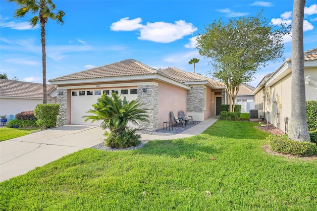 9081 Saint Andrews Way, Mount Dora, FL 32757 - view of front of home featuring stone siding, central AC unit, stucco siding, a tiled roof, and a garage