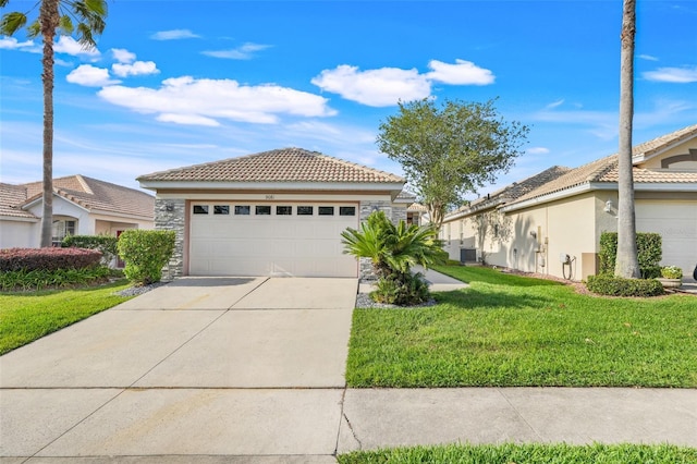 9081 Saint Andrews Way, Mount Dora, FL 32757 - view of front of house with a tiled roof, central AC unit, a front lawn, and concrete driveway
