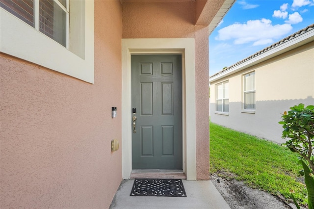 9081 Saint Andrews Way, Mount Dora, FL 32757 - view of exterior entry with stucco siding
