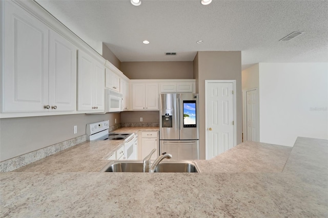 9081 Saint Andrews Way, Mount Dora, FL 32757 - kitchen with white appliances, a sink, light countertops, white cabinetry, and recessed lighting