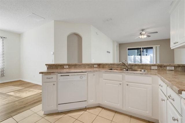 9081 Saint Andrews Way, Mount Dora, FL 32757 - kitchen featuring white dishwasher, a sink, a ceiling fan, light countertops, and white cabinetry