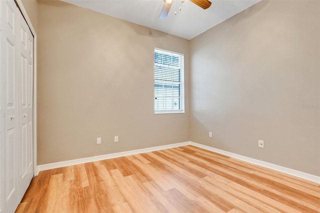 9081 Saint Andrews Way, Mount Dora, FL 32757 - unfurnished bedroom featuring light wood finished floors, a closet, baseboards, and a ceiling fan