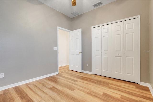9081 Saint Andrews Way, Mount Dora, FL 32757 - unfurnished bedroom featuring light wood-style flooring, baseboards, a closet, and ceiling fan