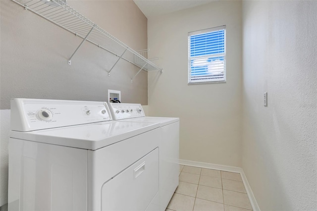 9081 Saint Andrews Way, Mount Dora, FL 32757 - laundry area with washer and clothes dryer, baseboards, and light tile patterned floors