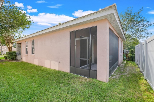9081 Saint Andrews Way, Mount Dora, FL 32757 - back of property with stucco siding and a sunroom
