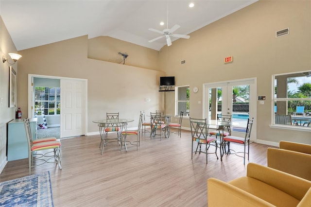 9081 Saint Andrews Way, Mount Dora, FL 32757 - dining space featuring french doors, high vaulted ceiling, ceiling fan, light wood finished floors, and plenty of natural light