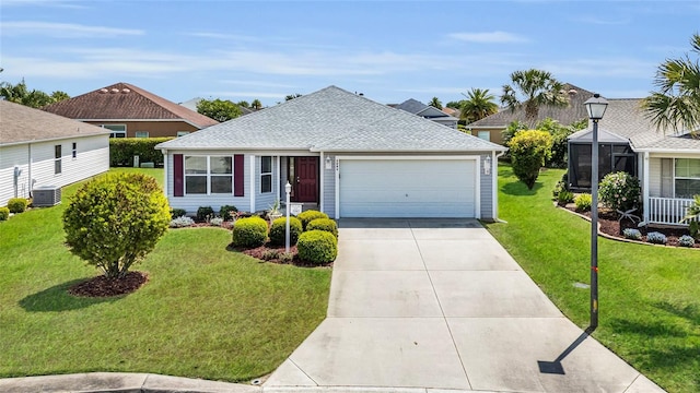 ranch-style home with concrete driveway, an attached garage, a front yard, central AC, and a shingled roof