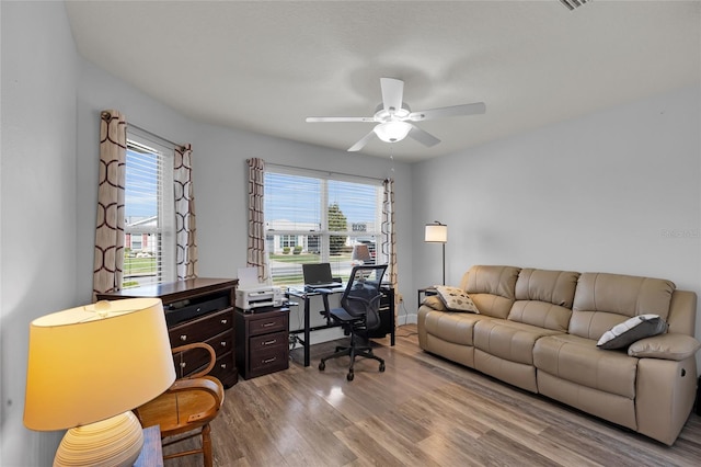 home office with a ceiling fan and wood finished floors