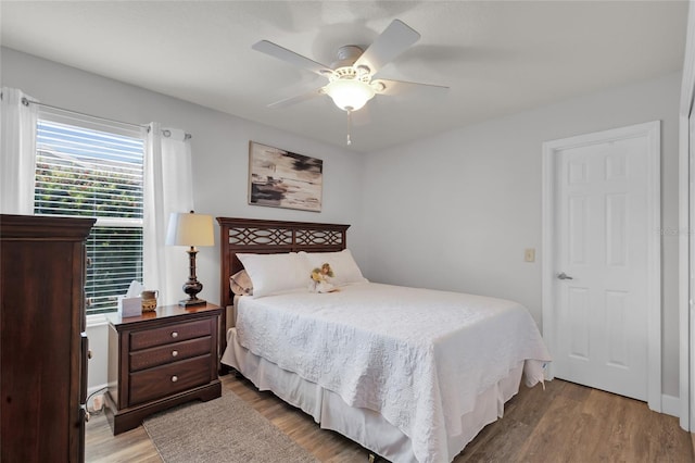 bedroom with a ceiling fan and wood finished floors