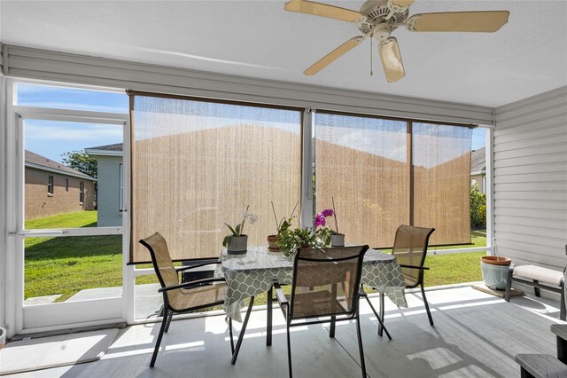 sunroom with outdoor dining space, plenty of natural light, and ceiling fan