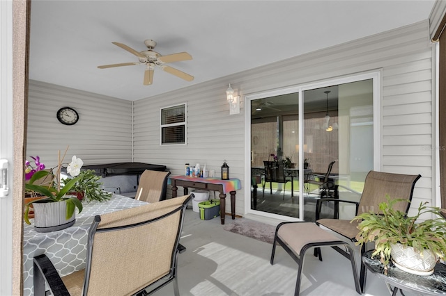 sunroom / solarium featuring outdoor dining space and a ceiling fan