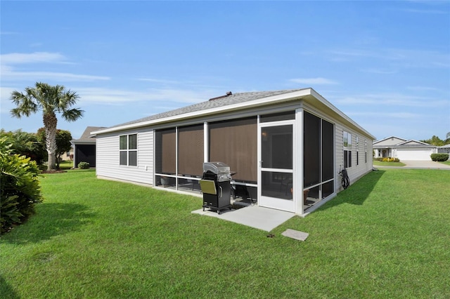rear view of property with a sunroom and a yard
