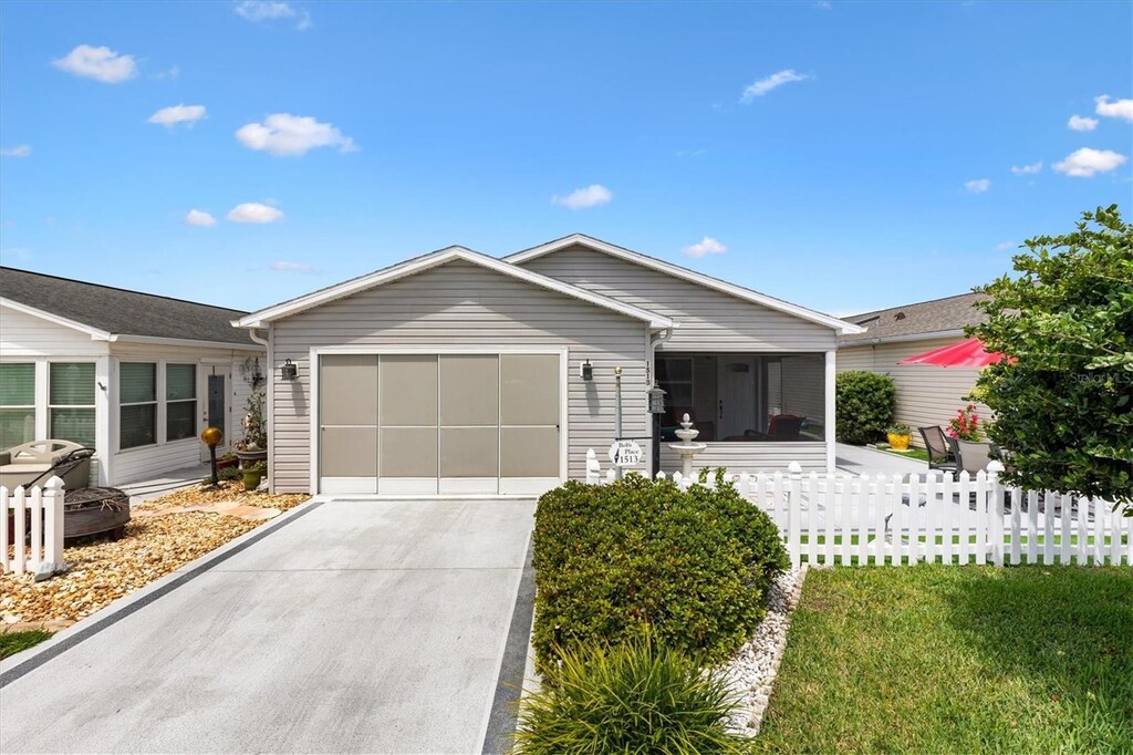 1513 Lozano Ave, The Villages, FL 32159 - ranch-style home featuring an attached garage, concrete driveway, and fence