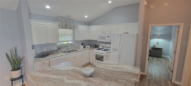 kitchen featuring white appliances, white cabinetry, wood finished floors, a sink, and lofted ceiling