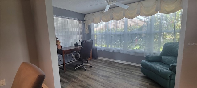 office space featuring ceiling fan, wood finished floors, and baseboards