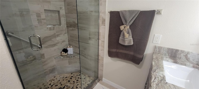 full bathroom with a shower stall and a sink