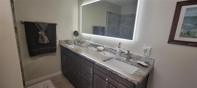 bathroom with a sink, baseboards, and double vanity