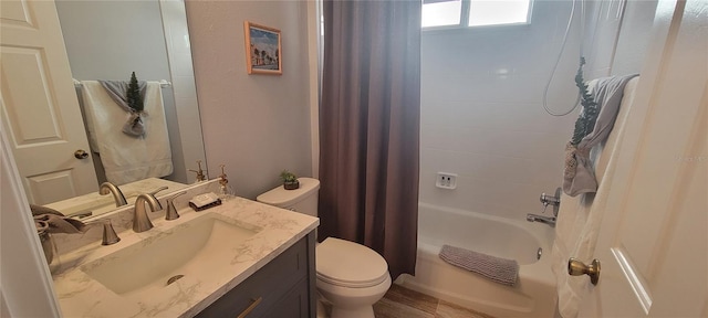 bathroom with shower / tub combo, toilet, and vanity