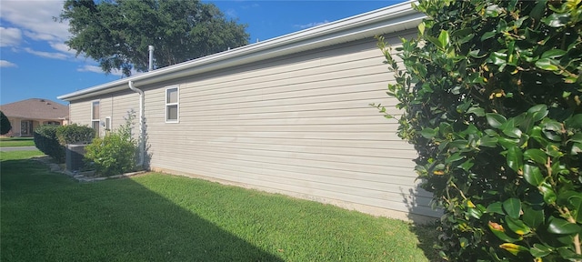 view of side of home featuring a lawn