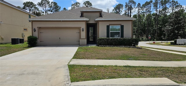 view of front of home with stucco siding, a front lawn, an attached garage, a shingled roof, and concrete driveway
