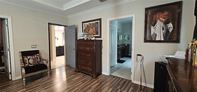 hall with dark wood-style flooring, baseboards, and ornamental molding