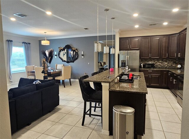kitchen with tasteful backsplash, ornamental molding, stainless steel fridge, and light tile patterned floors