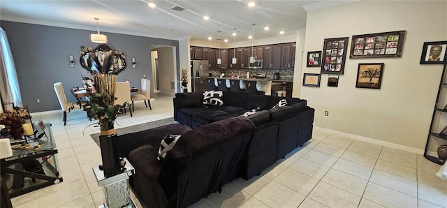 living room featuring ornamental molding, light tile patterned floors, baseboards, and visible vents