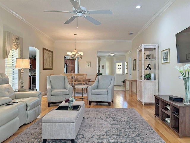 3325 Archer Ave, The Villages, FL 32162 - living area featuring light wood-style flooring, arched walkways, a chandelier, ceiling fan, and crown molding