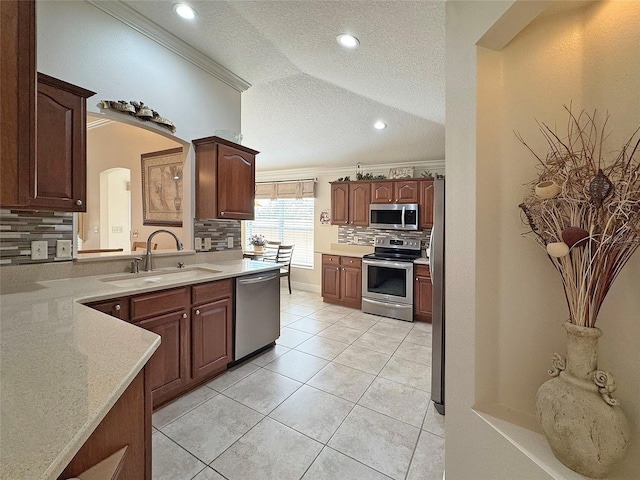 3325 Archer Ave, The Villages, FL 32162 - kitchen featuring appliances with stainless steel finishes, a sink, a textured ceiling, backsplash, and light tile patterned floors