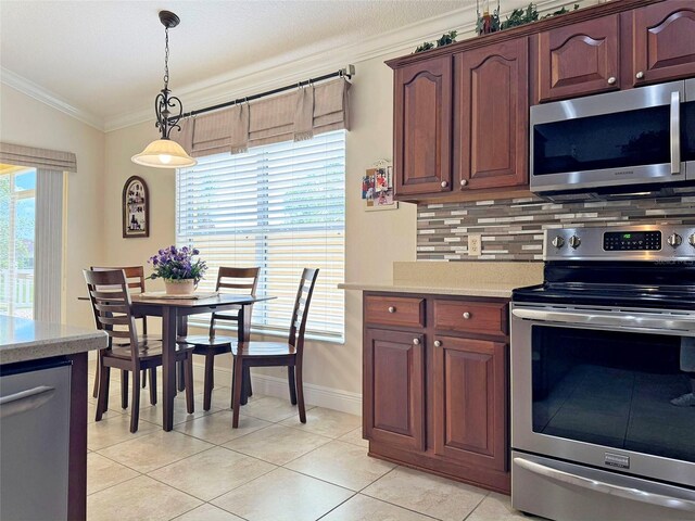 3325 Archer Ave, The Villages, FL 32162 - kitchen featuring appliances with stainless steel finishes, ornamental molding, light countertops, tasteful backsplash, and decorative light fixtures