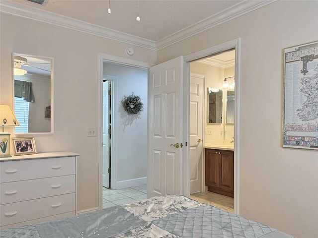 3325 Archer Ave, The Villages, FL 32162 - bedroom featuring crown molding, light tile patterned floors, connected bathroom, and baseboards
