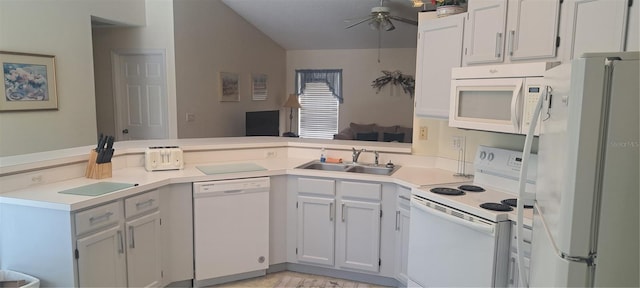 2855 Picadilly Cir, Kissimmee, FL 34747 - kitchen with white appliances, light countertops, a peninsula, a ceiling fan, and vaulted ceiling