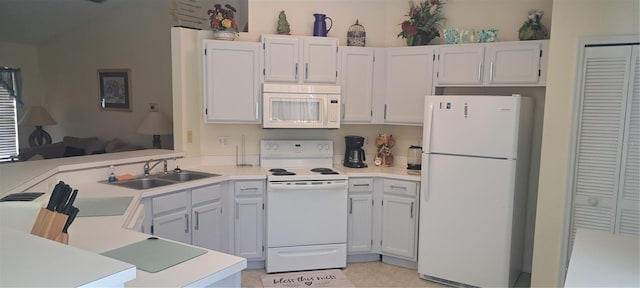 2855 Picadilly Cir, Kissimmee, FL 34747 - kitchen featuring white appliances, a peninsula, light countertops, and white cabinetry