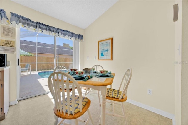 2855 Picadilly Cir, Kissimmee, FL 34747 - dining space featuring vaulted ceiling and baseboards