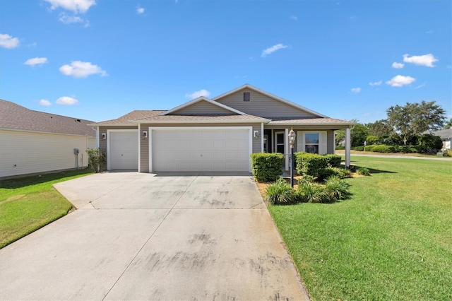 ranch-style home featuring a front lawn, driveway, a shingled roof, and a garage