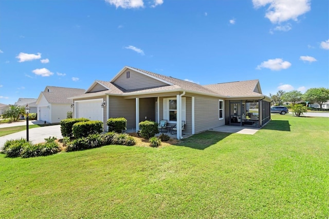view of front of house with an attached garage, a front lawn, roof with shingles, and concrete driveway