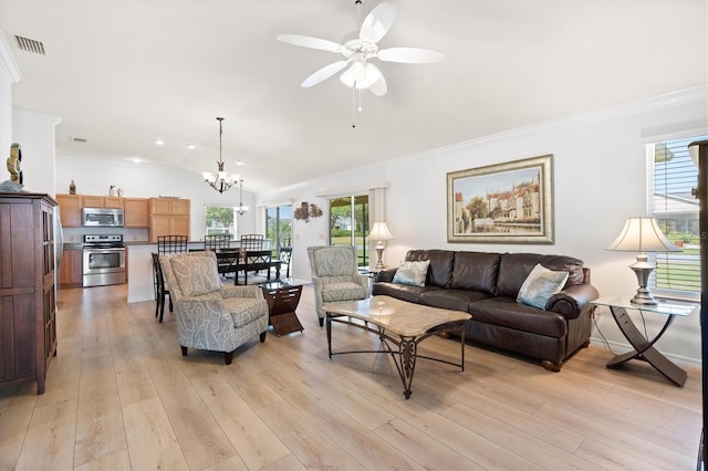 living area with vaulted ceiling, visible vents, ceiling fan with notable chandelier, and a healthy amount of sunlight