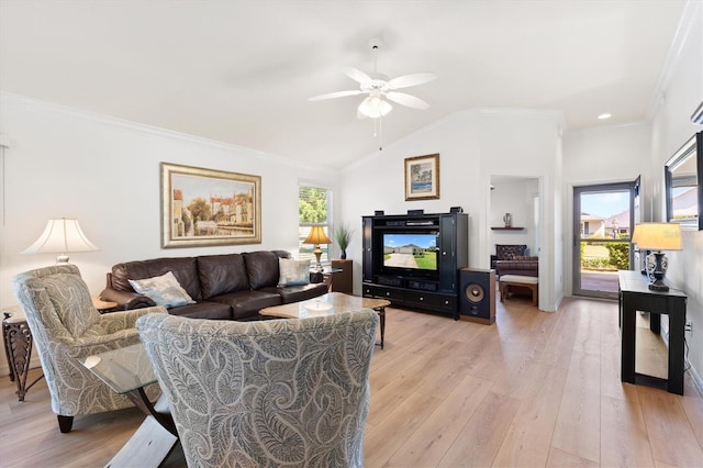 living area featuring vaulted ceiling, light wood-type flooring, ornamental molding, and ceiling fan